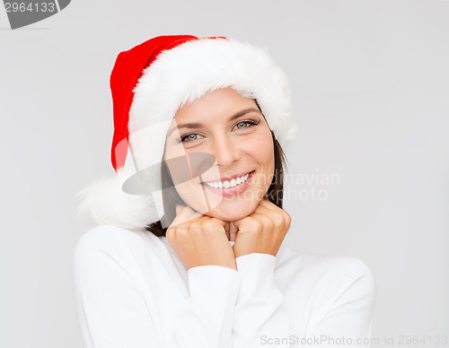 Image of smiling woman in santa helper hat