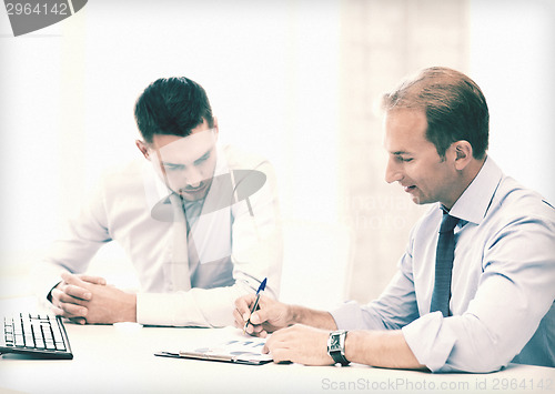 Image of businessmen with notebook on meeting