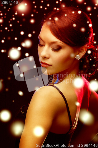 Image of woman in evening dress wearing diamond earrings