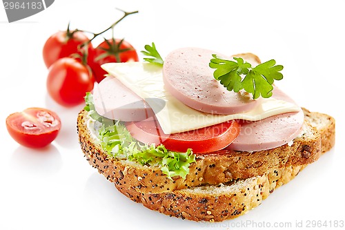 Image of breakfast sandwich with sliced sausage and tomato