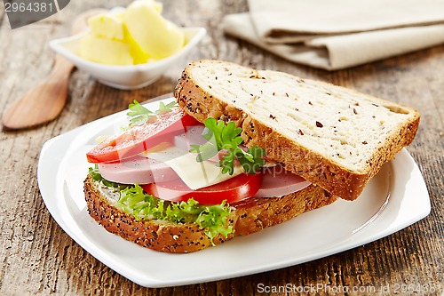 Image of breakfast sandwich with sliced sausage and tomato