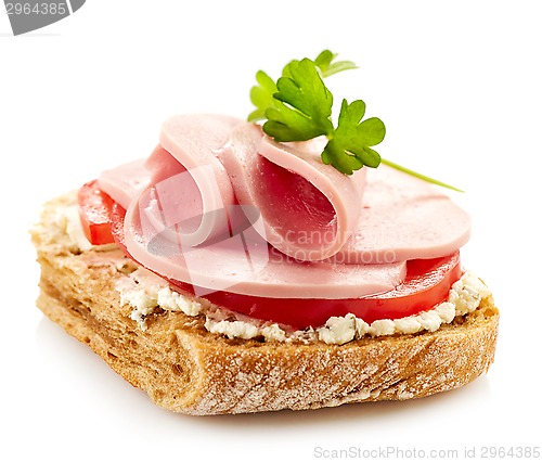 Image of breakfast sandwich with sliced sausage and tomato