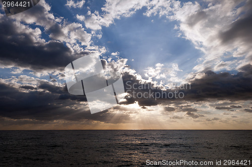 Image of sun shining through clouds