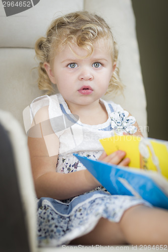 Image of Blonde Haired Blue Eyed Little Girl Reading Her Book