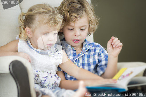Image of Young Brother and Sister Reading a Book Together