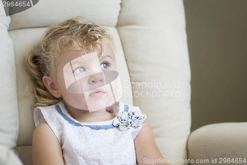 Image of Adorable Blonde Haired and Blue Eyed Little Girl in Chair