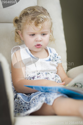 Image of Blonde Haired Blue Eyed Little Girl Reading Her Book