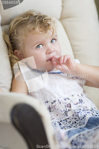 Image of Adorable Blonde Haired and Blue Eyed Little Girl in Chair