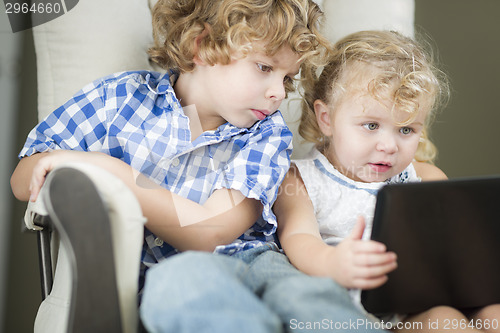 Image of Young Brother and Sister Using Their Computer Laptop Together