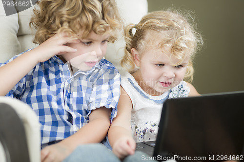 Image of Young Brother and Sister Using Their Computer Laptop Together