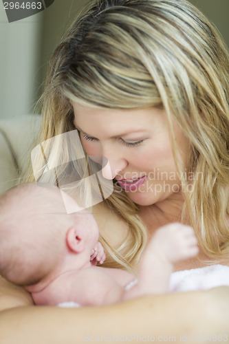 Image of Young Beautiful Mother Holding Her Precious Newborn Baby Girl