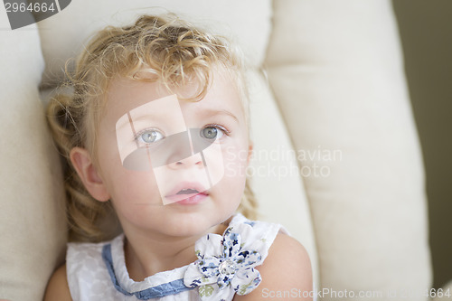 Image of Adorable Blonde Haired and Blue Eyed Little Girl in Chair