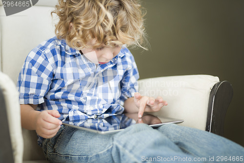 Image of Young Blond Boy Using His Computer Tablet