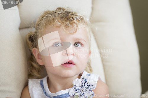 Image of Adorable Blonde Haired and Blue Eyed Little Girl in Chair