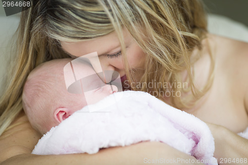 Image of Young Beautiful Mother Holding Her Precious Newborn Baby Girl