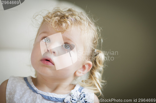 Image of Adorable Blonde Haired and Blue Eyed Little Girl in Chair