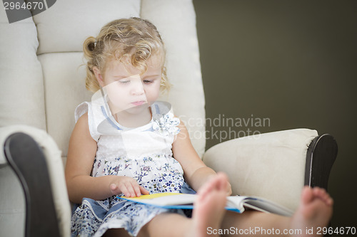Image of Blonde Haired Blue Eyed Little Girl Reading Her Book