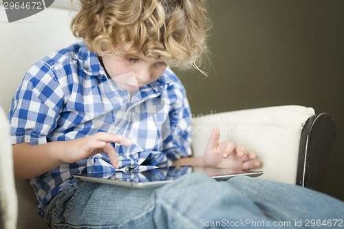 Image of Young Blond Boy Using His Computer Tablet