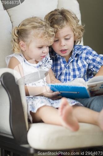 Image of Young Brother and Sister Reading a Book Together