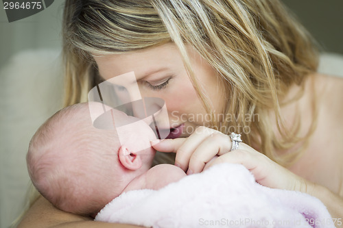 Image of Young Beautiful Mother Holding Her Precious Newborn Baby Girl