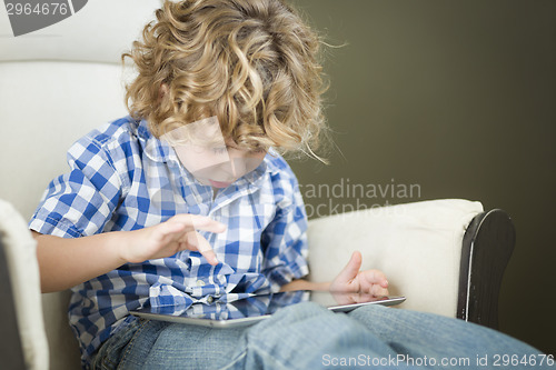 Image of Young Blond Boy Using His Computer Tablet