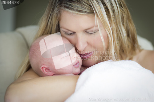 Image of Young Beautiful Mother Holding Her Precious Newborn Baby Girl