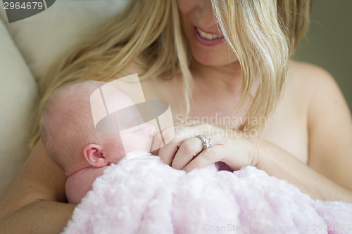 Image of Young Beautiful Mother Holding Her Precious Newborn Baby Girl