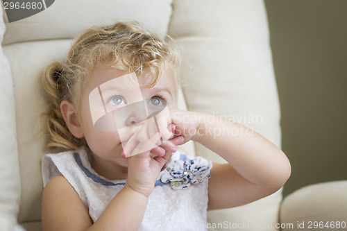 Image of Adorable Blonde Haired and Blue Eyed Little Girl in Chair