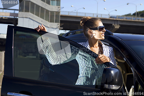 Image of happy business woman near city bridge