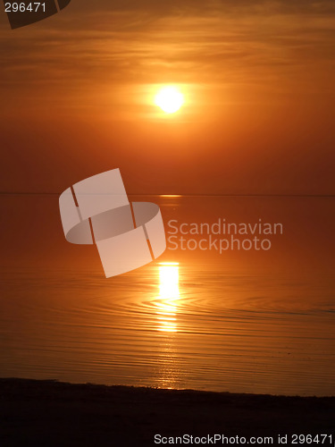 Image of Orange sunset above a quiet serene gulf