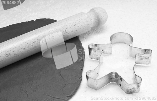 Image of Gingerbread dough, rolling pin and cookie cutter