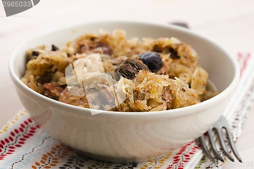 Image of traditional polish sauerkraut (bigos) with mushrooms and plums