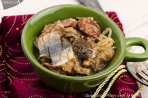 Image of traditional polish sauerkraut (bigos) with mushrooms and plums