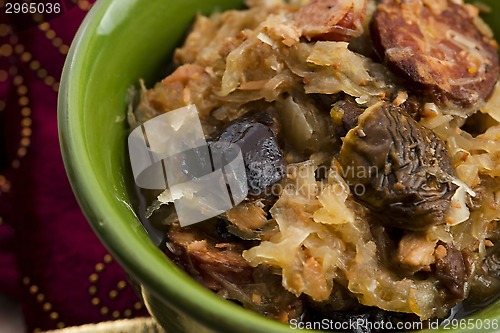 Image of traditional polish sauerkraut (bigos) with mushrooms and plums