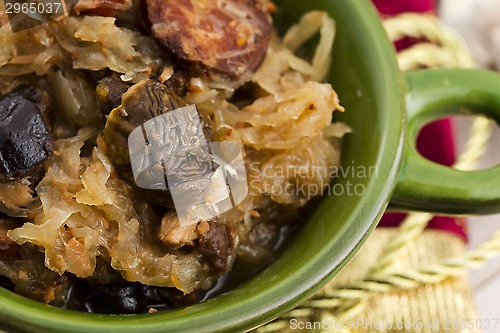 Image of traditional polish sauerkraut (bigos) with mushrooms and plums