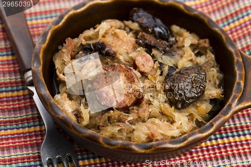 Image of traditional polish sauerkraut (bigos) with mushrooms and plums