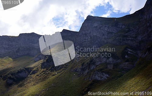 Image of Autumn sunlit mountains in a cloudy day