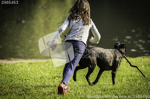 Image of  young girl and dog on the grass