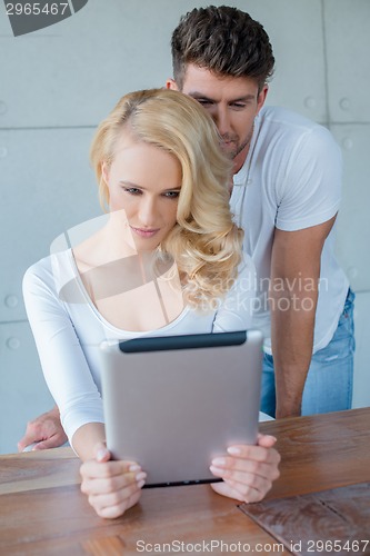 Image of Beautiful woman reading information on a tablet