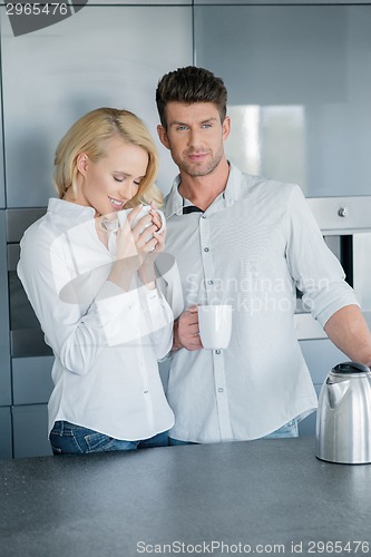 Image of Handsome man and his wife enjoying coffee