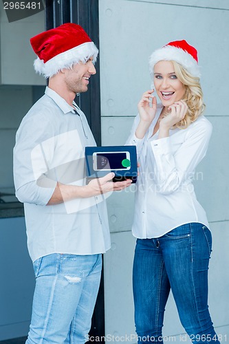 Image of Husband giving his wife a Christmas gift