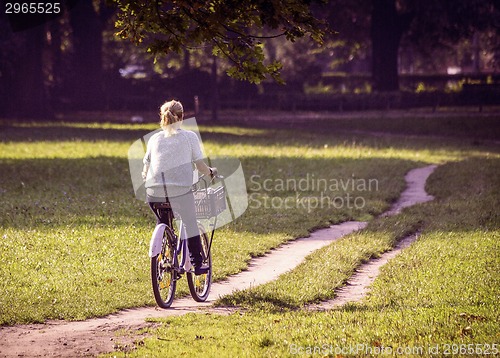 Image of Young woman on bike