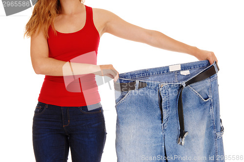 Image of Woman holding big pants.