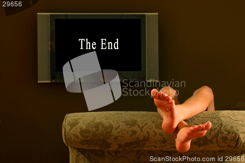 Image of child reclining feet up watching the end of a movie