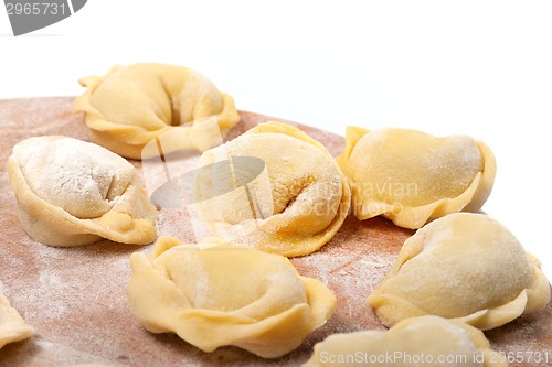 Image of Homemade ravioli on kitchen wooden board