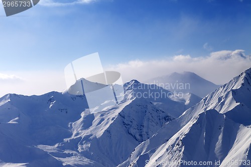 Image of Snowy mountains in early morning fog