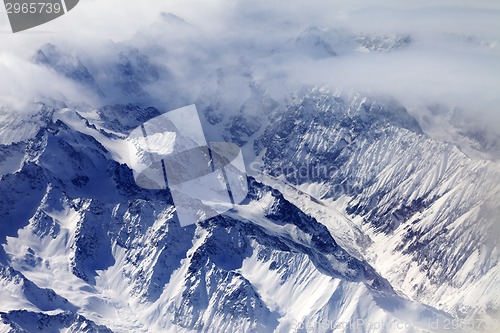 Image of Top view on snow mountains and glacier in mist