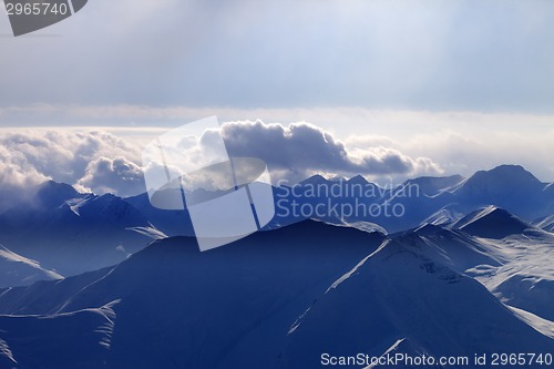 Image of Silhouette of evening mountains in mist