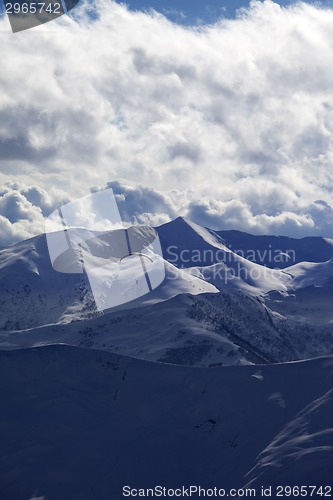 Image of Evening sunlight mountain with clouds and silhouette of paraglid