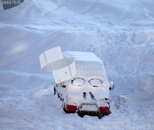 Image of Snow-covered car with smiley in windshield